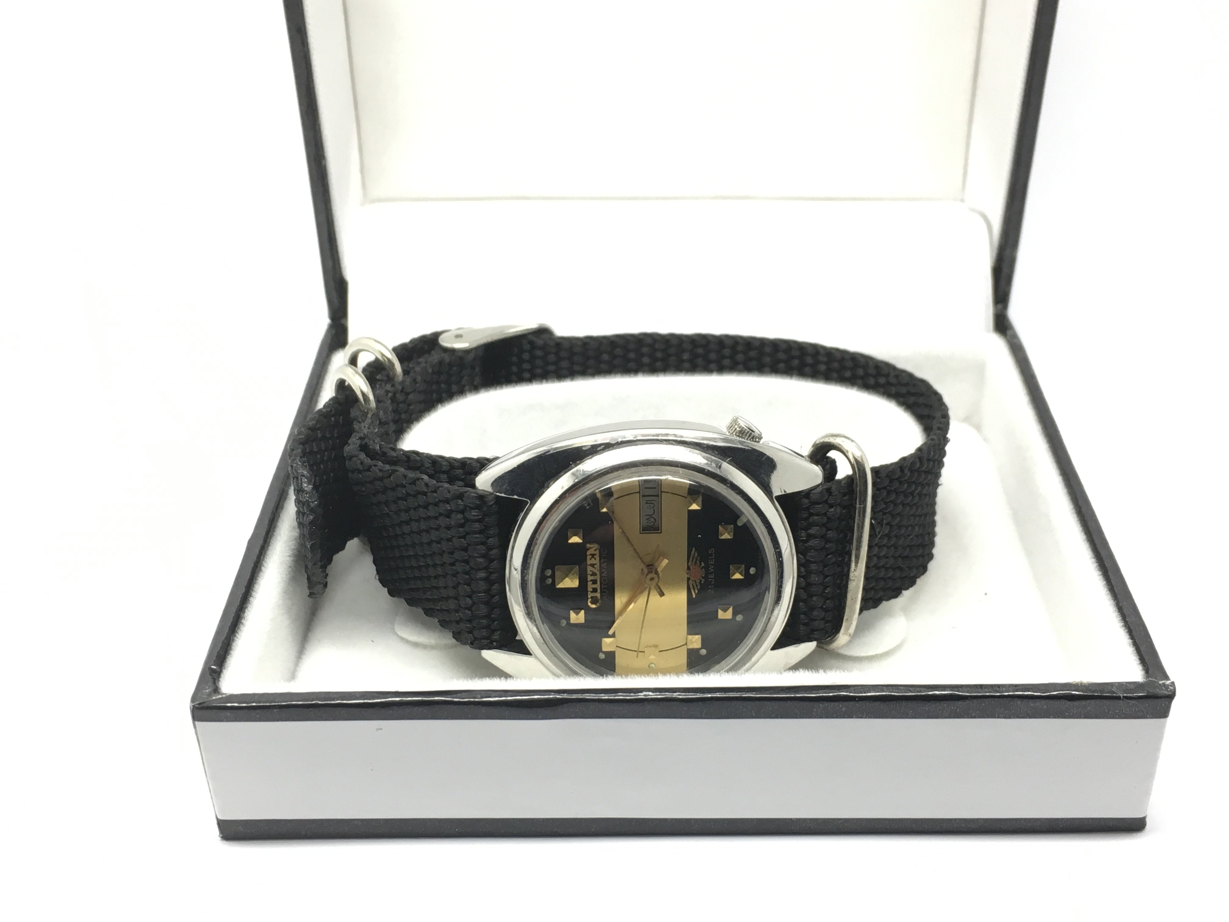 A Citizen automatic watch with black and gold tone