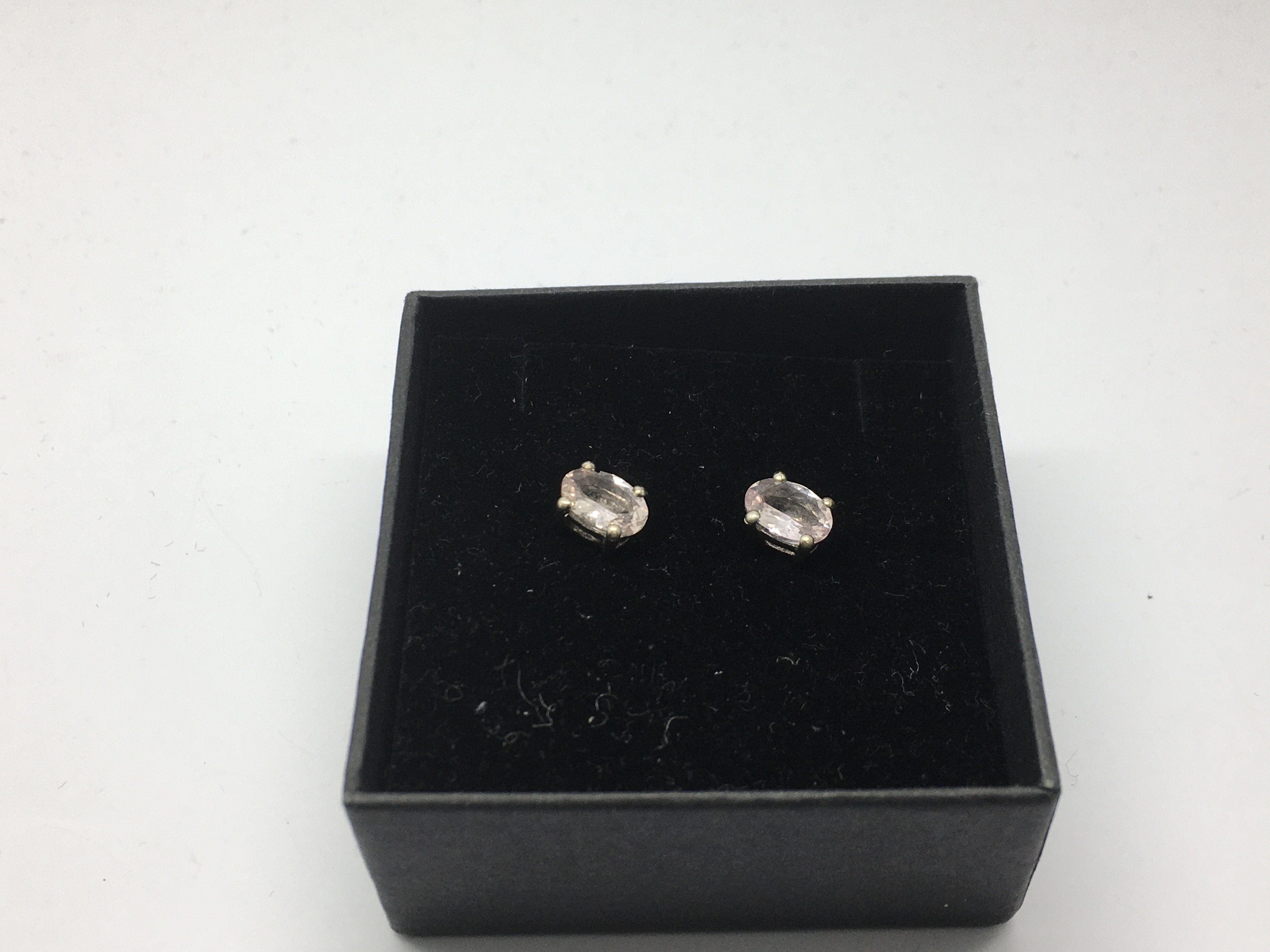 A pair of silver studs set with morganite.