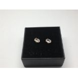 A pair of silver studs set with morganite.