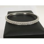 A 18 ct white gold bangle inset with 26 equal size