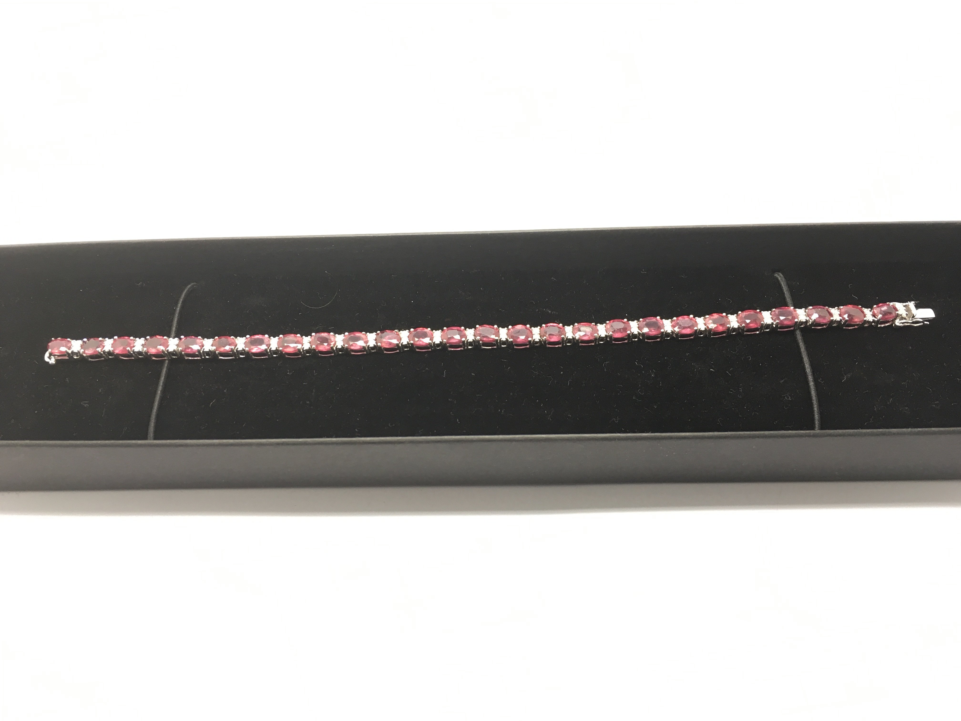 An 18ct white gold, ruby and diamond line bracelet