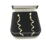 A pair of unusual gold drop earrings