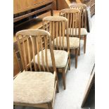 A set of modern design teak chairs with shaped bac
