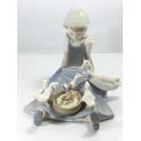 A large Lladro figure of a young girl feeding duck