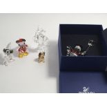 A collection of Disney Swarovski Crystal figures Christmas Mickey Mouse Minnie Mouse Pluto and a box