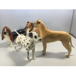 Four medium sized Beswick dog figures including a