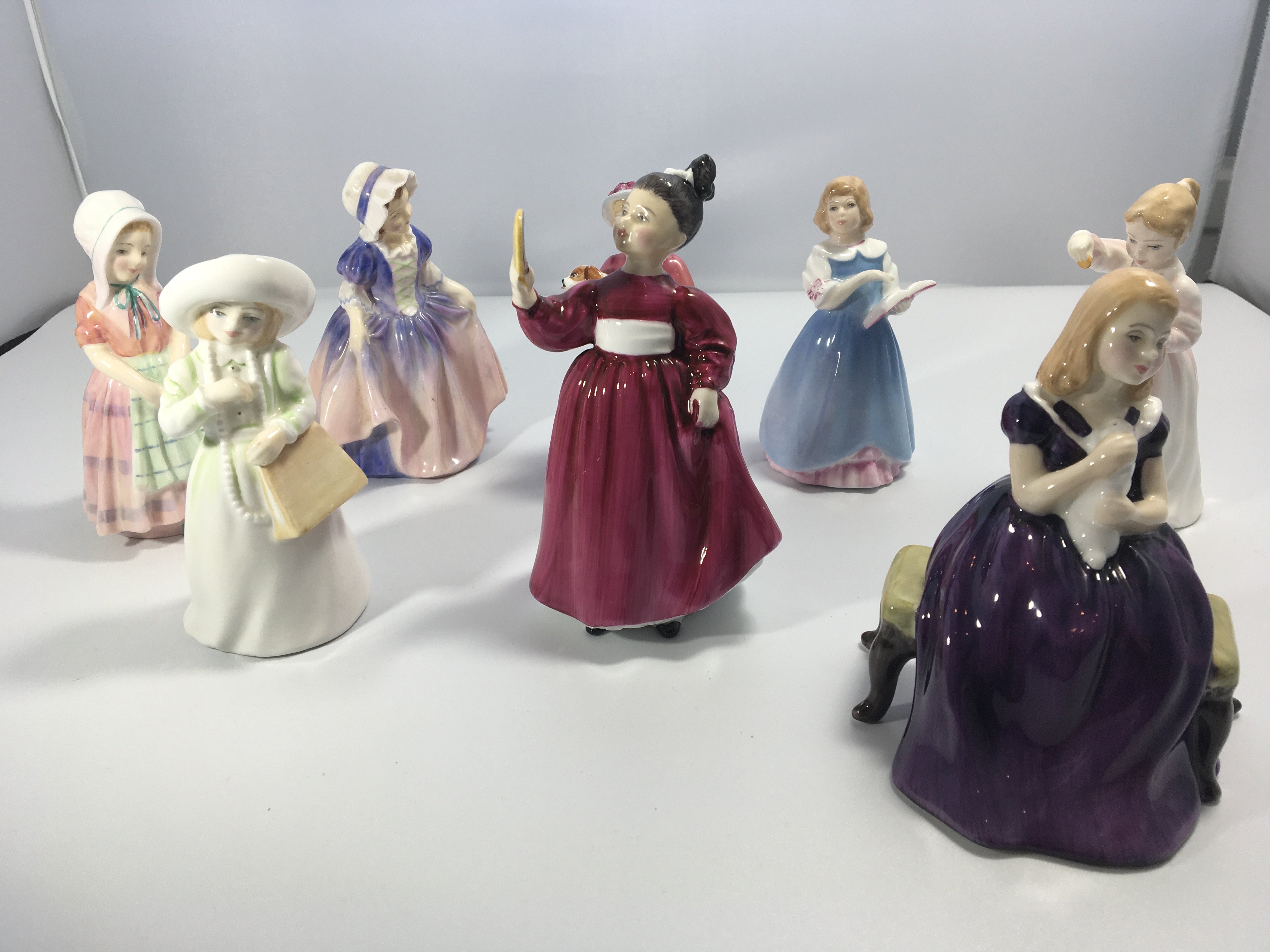 A collection of eight Royal Doulton porcelain figu