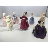 A collection of eight Royal Doulton porcelain figu