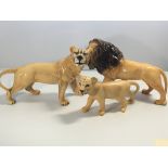 Three Beswick lion figures including a cube.height