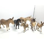 A collection of Beswick Donkeys and a small pony a