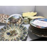 A collection of decorative plates and dishes including Clarice Cliff Carlton Ware and other ceramics