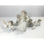 A group of four Lladro cherubs one playing a flute