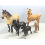 A Beswick Highland pony a Shetland pony and a Palo