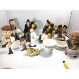 A collection of Royal Doulton and Wade figures including Tetley tea money boxes The Balloon man and