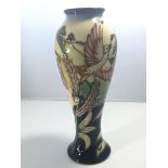 A Moorcroft vase decorated with flying birds a lim