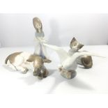 A collection of Lladro figures a calf a cat a goos