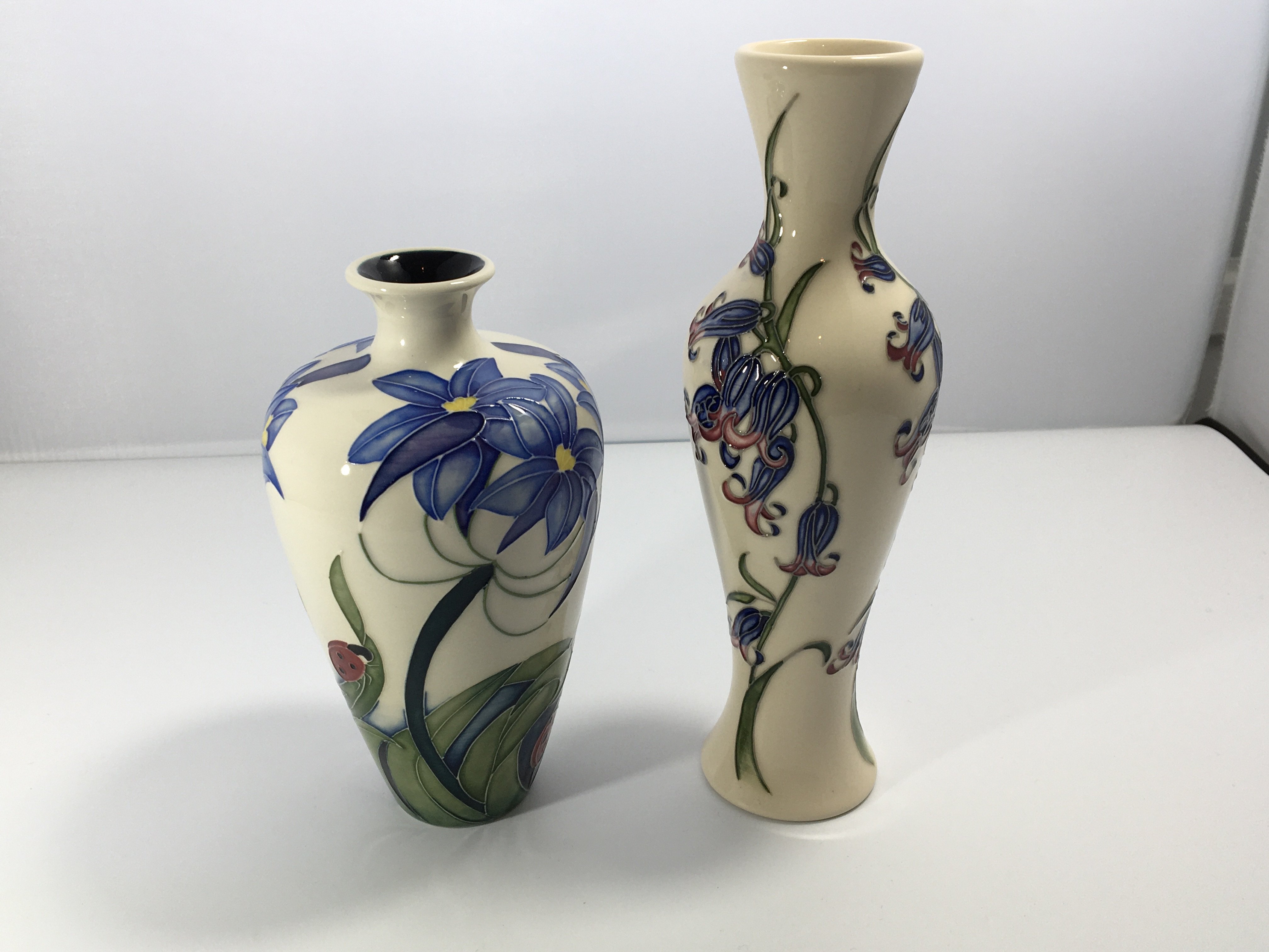 Two modern Moorcroft vases decorated with blue bel