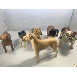 A collection of six Beswick medium size 17cm dog f