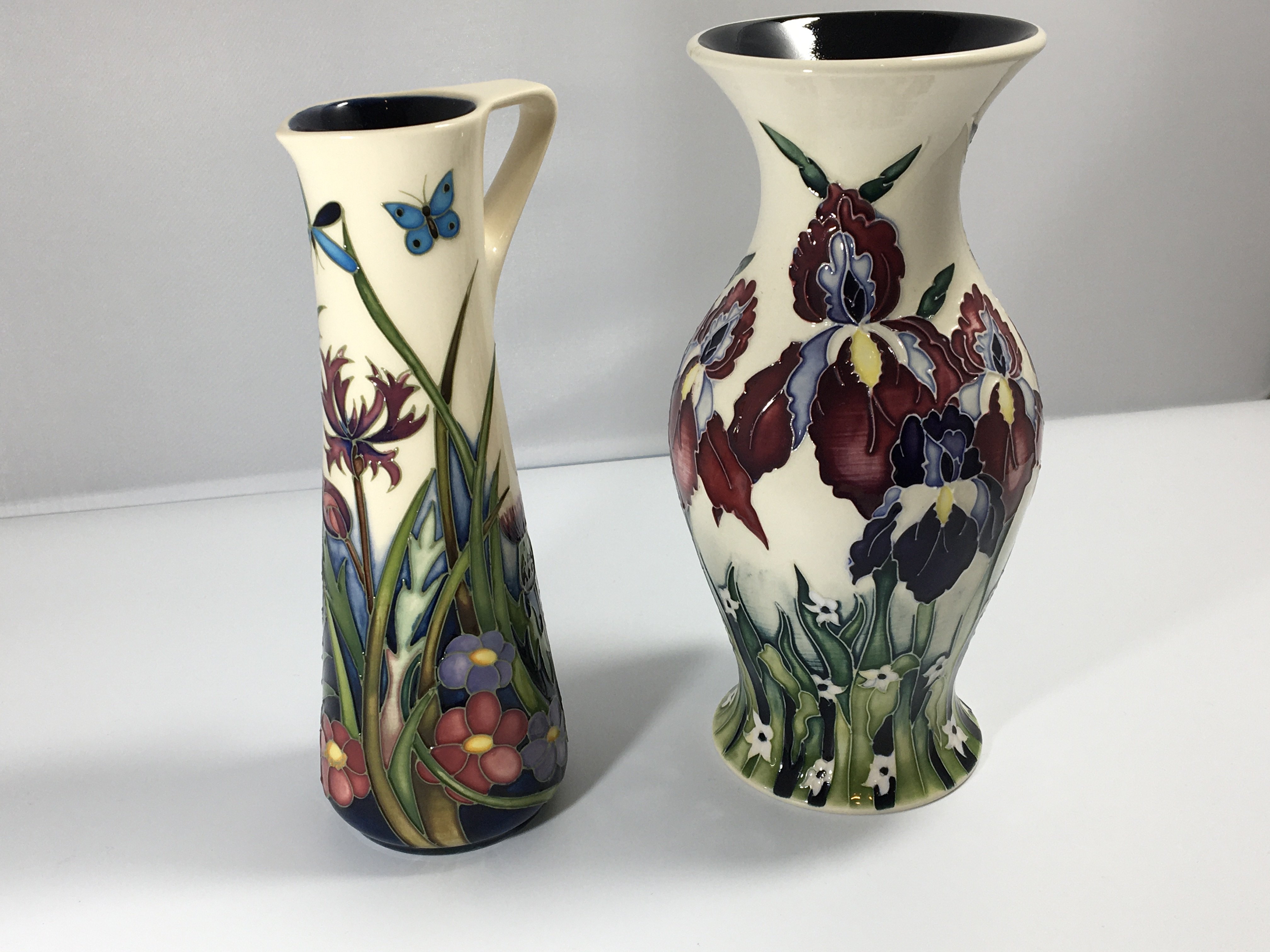 A Moorcroft jug decorated with thistle a d wild fl