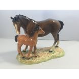 A Beswick horse figure group with a bay mare with