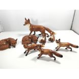 A collection of Beswick Fox figures all with the e