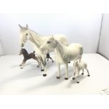 Two Beswick dapple grey horses and foal and two ot
