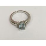 A 18 ct gold ring inset with central aquamarine fl