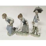 Three Lladro figures of young girls one holding an