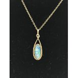 A 9ct opal doublet pendant and chain.