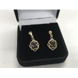 A pair of 9ct gold and garnet set earrings.