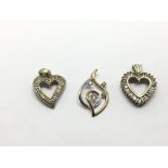 Three 9ct gold heart shaped diamond pendants, appr