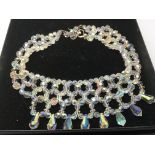 An aurora crystal choker and a matching pair of ea