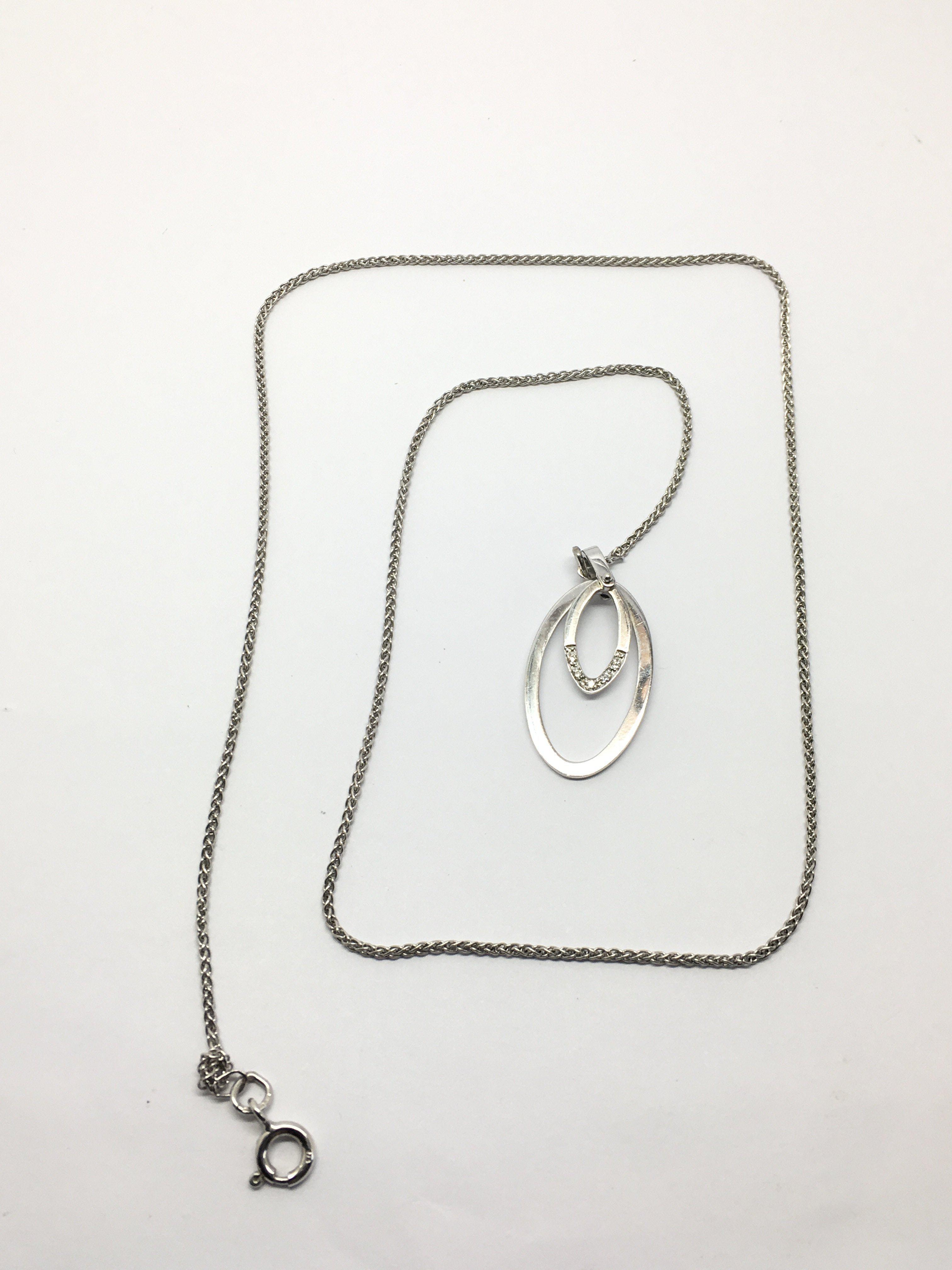 A 9ct white gold pendant set with diamonds, approx