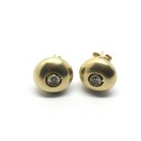 A pair of 18ct gold diamond stud earrings, approx