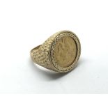 A 9ct gold ring inset with a 1909 half sovereign,