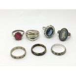 A collection of seven silver rings.