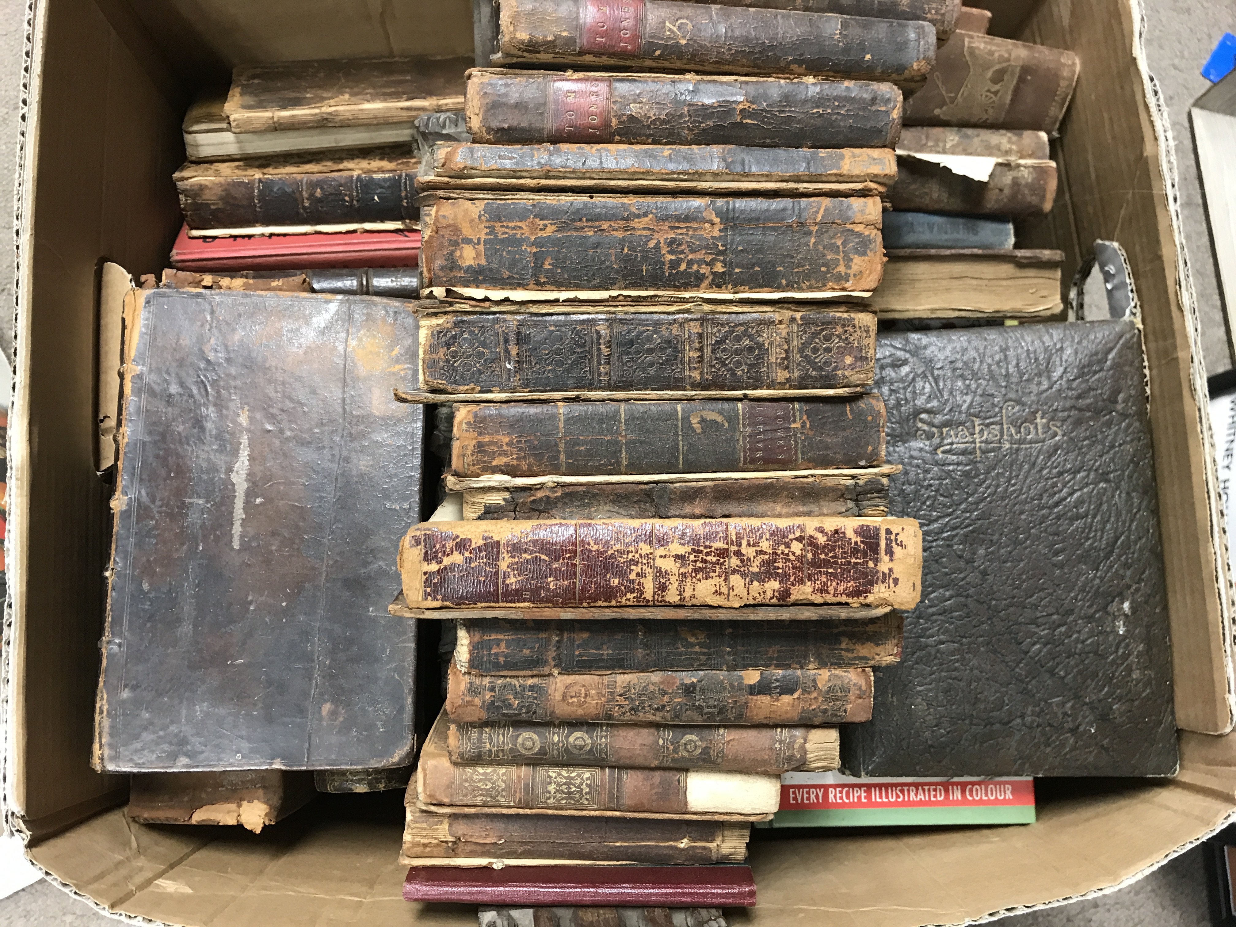 A box of leather bound early books etc.