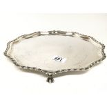 A Silver salver, with a gadrooned edge and claw fe