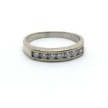 An 18ct white gold seven diamond half eternity rin