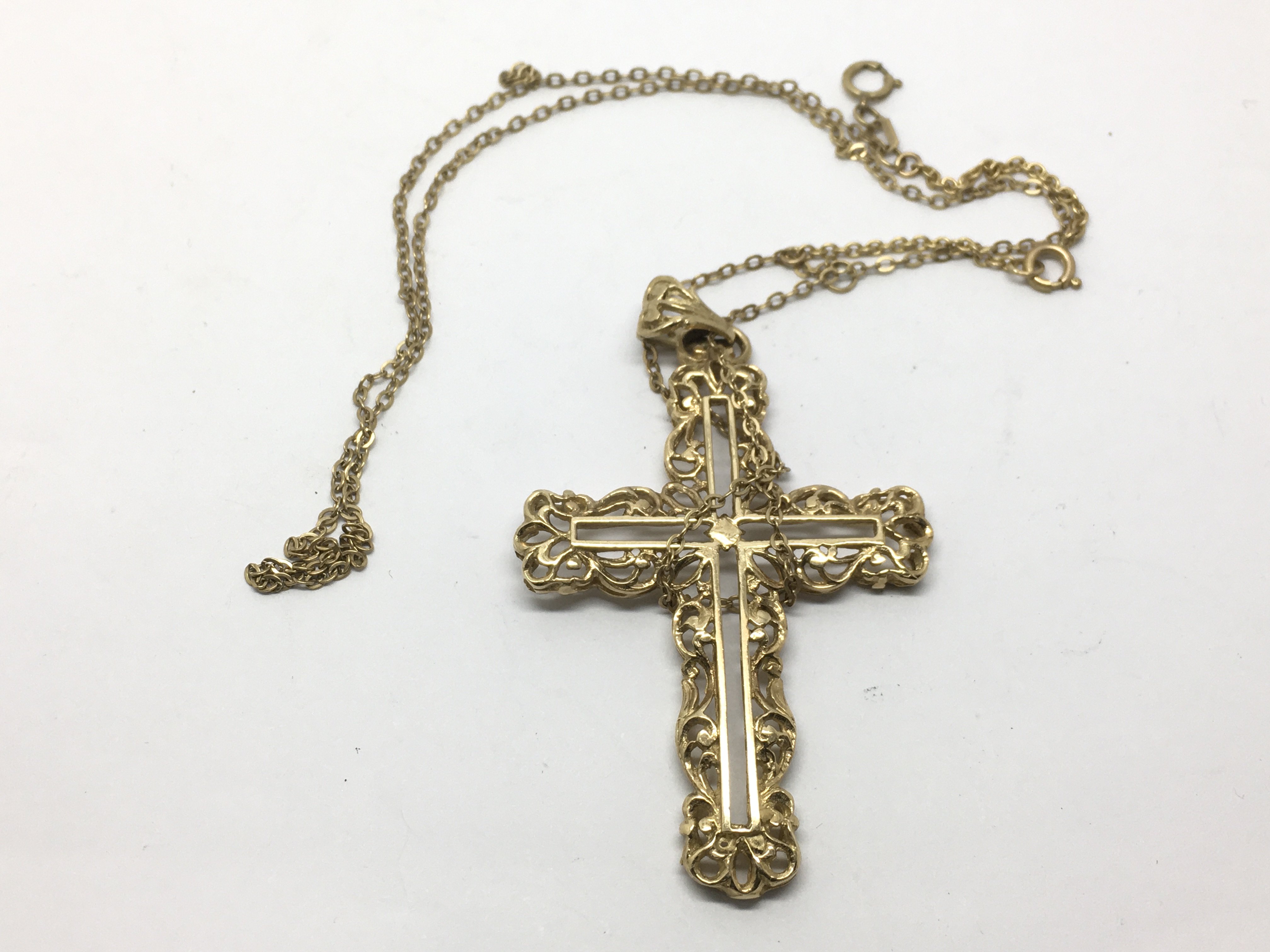 A 9ct gold cross on chain, approx length of cross