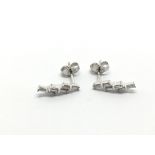 A pair of 9ct white gold earrings set with baguett