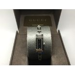 A boxed Gucci ladies diamond dial dress watch.