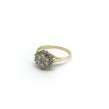An 18carat gold ring set with a round floral patte