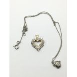 Two 18ct white gold pendants comprising a heart sh