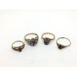 Four gold rings set with stones comprising ruby, d