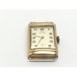 A gold cased vintage Record watch with squared dia