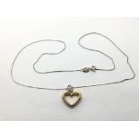An 18ct gold heart shaped pendant set with small d