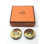 A boxed pair of Hermes clips.