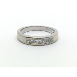 An 18ct white gold ring with seven princess cut di