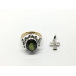 An 18ct gold and platinum ring set with a green to